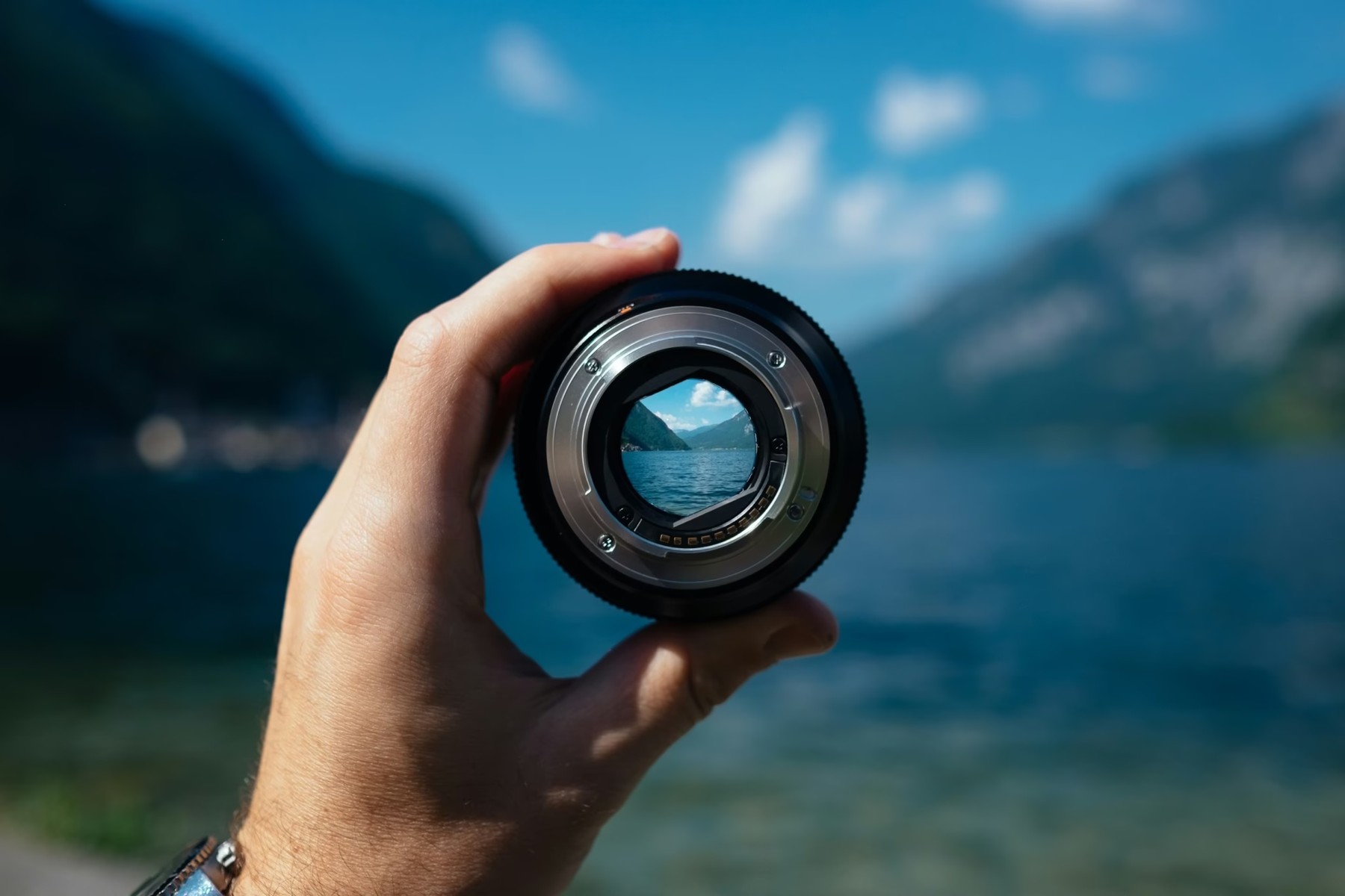 A camera lens framing a clear view of a mountain landscape